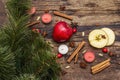 Spirit Christmas background. New Year tree, fresh apple, cinnamon, dog rose, candles, cardamom, star anise. Nature decorations,