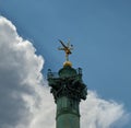 Spirit of Freedom highlighted as the sun breaks through storm clouds in Place Bastille, Paris