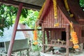 Spirit house in thailand with garland and some wreathes,