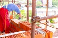 Spirit level placed on red bricks, worker builds wall with blocks and mortar, building site Royalty Free Stock Photo