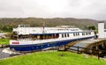 A Spirit of Scotland boat coming from Loch Oich into the Caledonian Canal through opened Aberchalder swing bridge, Scottish Highla