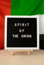 SPIRIT OF THE UNION text frame on United Arab Emirates waving flag made from silk material. Independence Commemoration Royalty Free Stock Photo