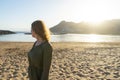 Spiritual adolescent in green dress admire the sunset and the sea town on a hill in Tenerife. Blonde romantic woman look the Royalty Free Stock Photo