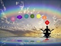 Spiritual background with chakras, human silhouette and rainbow in sea reflection