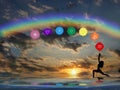 Spiritual background with chakras, human silhouette and rainbow in sea reflection Royalty Free Stock Photo