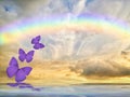 Spiritual background for meditation with butterflies, stormy clouds and rainbow in sea reflection Royalty Free Stock Photo