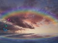 Spiritual background for meditation with clouds sky, rainbow and butterflies Royalty Free Stock Photo