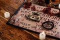 Spiritual board ouija with candles close-up. Mystical ritual of calling dead spirits. Macro Royalty Free Stock Photo