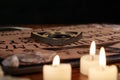 Spiritual board ouija with candles close-up. Mystical ritual of calling dead spirits. Macro Royalty Free Stock Photo