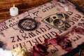 Spiritual board ouija with candles close-up. Mystical ritual of calling dead spirits Royalty Free Stock Photo
