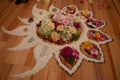 spiritual ceremony with flowers and rice in the shape of a moon, sun, fire and star on a wooden floor, shaman