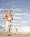 Spiritual Man with Ball of Light Practises Tai Chi