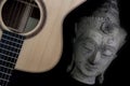 Spiritual music. Buddha meditating with folk acoustic guitar