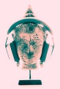 Spiritual music therapy. Bright contemporary image of Buddha head with headphones.
