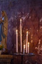 Spiritual or religious light with altar candles by Virgin Mary Royalty Free Stock Photo