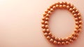 Spiritual Rudraksha Bracelet from the seeds of the Rudraksha tree on peach background. Copy space Royalty Free Stock Photo