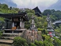 Spiritual Sentinels: Stone Figures Inside Temple In Miyajima, Hiroshima, Japan