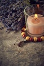 Spiritual still life with candles, beads and dry flowers