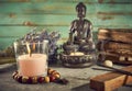 Spiritual still life with candles, beads, statue of Buddha and dry flowers