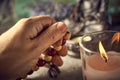 Spiritual still life with candles, beads, statue of Buddha and dry flowers