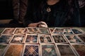 Spiritual wicca witch reading occult mystic old tarot cards laying on table for a magical pagan ritual psychic destiny reading