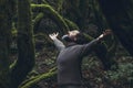 Spiritual zenlike nature love people. One man with closed eyes and outstretching arms in the nature forest green trees scenic Royalty Free Stock Photo