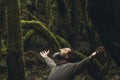 Spiritual zenlike nature love people. One man with closed eyes and outstretching arms in the nature forest green trees scenic