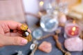 spiritualistic session in salon of soothsayer, fortune-teller, hands of female medium, alchemist, herbalist hold witchcraft potion Royalty Free Stock Photo