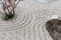 Spirituality and purity stone in sand circles spa background in zen garden concept for relaxation concentration and meditation Royalty Free Stock Photo