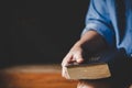 Hands folded in prayer on a Holy Bible in church concept for faith Royalty Free Stock Photo