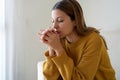 Spirituality and young people. Girl praying at home alone. Worried woman praying for strenght during russian invasion of Ukraine