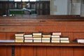 Spiritually Uplifting Hymn books stacked on church bench Royalty Free Stock Photo