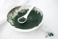 spirulina algae powder in a white bowl Royalty Free Stock Photo