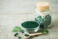 Spirulina tablets and powder in bowls