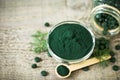 Spirulina tablets and powder in bowls Royalty Free Stock Photo