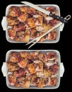 Spit Roasted Pork Meat Slices with Serving Fork and Knife in Ceramic Oblong Casserole and Oval Tray Isolated on Black Background Royalty Free Stock Photo