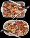 Spit Roasted Pork Meat Slices with Serving Fork and Knife in Ceramic Oblong Casserole and Oval Tray Isolated on Black Background Royalty Free Stock Photo