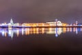 Spit Strelka of Vasilyevsky island with Rostral columns, Kunstkamera museum and Palace bridge at night during New Year and Chris Royalty Free Stock Photo