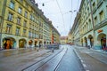 Spitalgasse street with colorful Pfeiferbrunnen fountainn and typical Bernese houses with arcades, on March 31 in Bern,