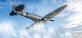 Spitfire fighter plane flying in blue sky