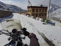 Spiti, Himachal Pradesh, India - April 7th, 2021 : Winter landscape in a fabulous location, Bike riding in snow covered village in
