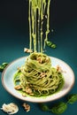 Splash abd levitation of delicious green pasta dish with pesto sauce and fresh herbs