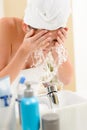 Splash in bathroom woman cleaning face Royalty Free Stock Photo