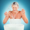 Splash beauty, senior and skincare for woman in studio for grooming, skin and hygiene on blue background mockup. Water