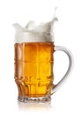 Splash in beer mug Royalty Free Stock Photo