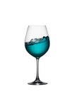 Splash of blue drink in glass on white isolated background. The splashing of blue water is like a sea wave in a glass. Royalty Free Stock Photo