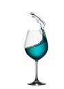 Splash of blue drink in glass on white isolated background. The splashing of blue water is like a sea wave in a glass. Royalty Free Stock Photo