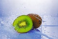 Splash of blue water on green slice of kiwi Royalty Free Stock Photo