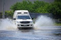 Splash by a car as it goes through flood Royalty Free Stock Photo