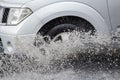 Splash by a car as it goes through flood water Royalty Free Stock Photo